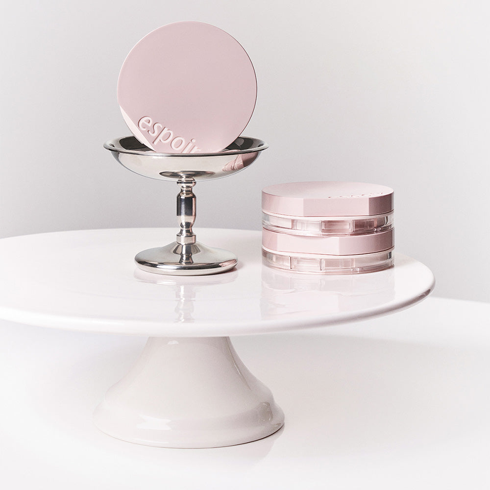 ESPOIR Be Natural Cushion SPF50+ PA++++ displayed on a modern stand, highlighting chic design and premium packaging.