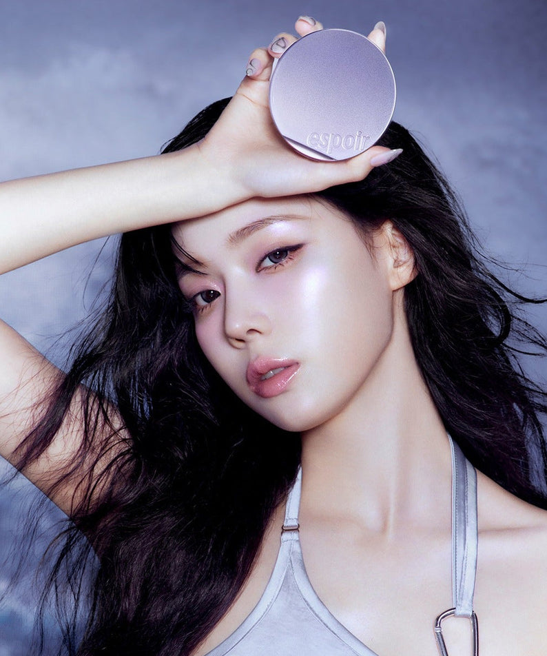 Model holding ESPOIR Bevelvet Cover Cushion SPF42 PA++ [Galaxy Beam Collection] against a galaxy-themed background.