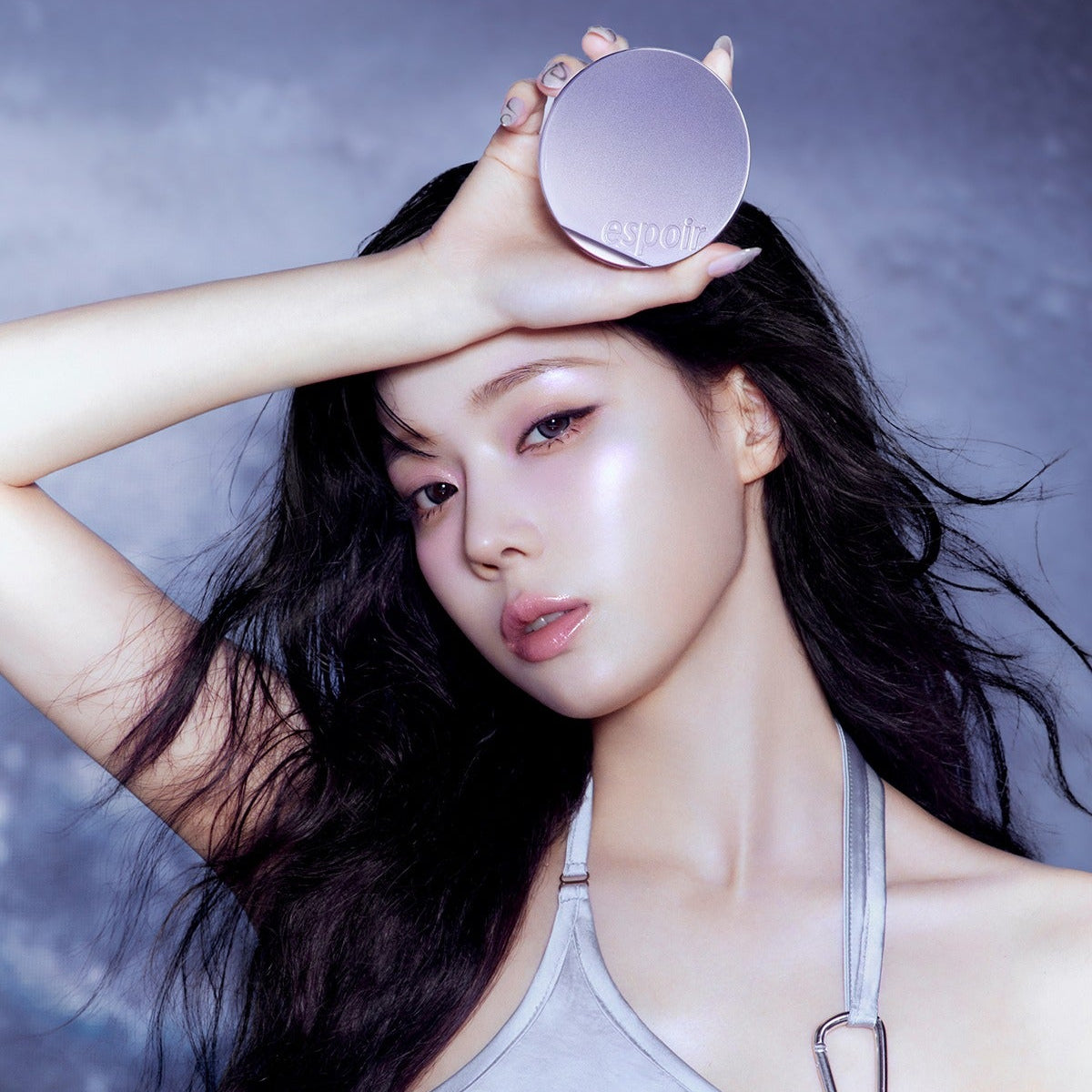 Model holding ESPOIR Bevelvet Cover Cushion SPF42 PA++ [Galaxy Beam Collection] against a galaxy-themed background.