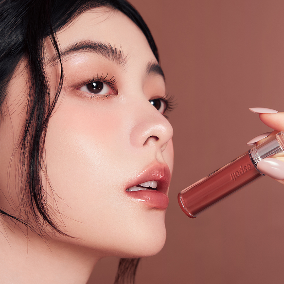 Model applying ESPOIR Couture Lip Tint Glaze [NEW COLOR] on lips