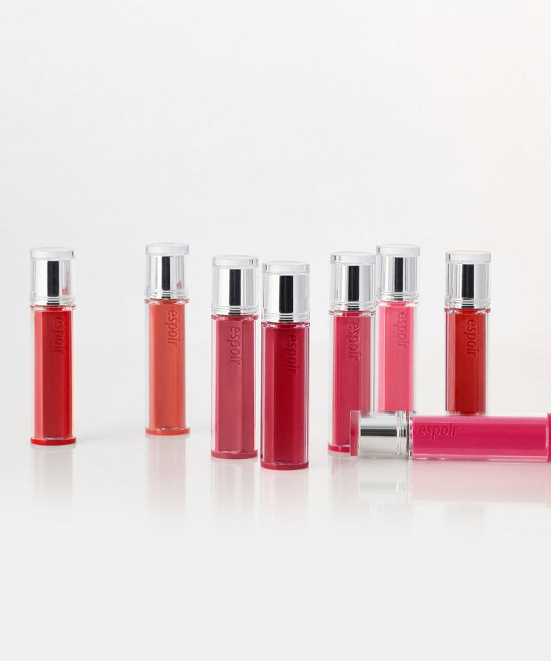 Collection of ESPOIR Couture Lip Tint Glaze in various shades displayed in tubes.