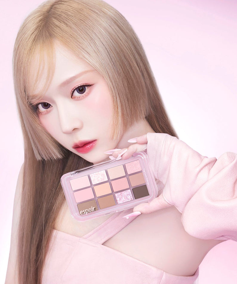 Model holding ESPOIR Eye Core Palette showcasing vibrant eyeshadow colors.