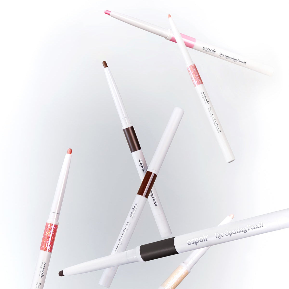 Various shades of ESPOIR Eye opening pencil floating in a stylish arrangement, showcasing their colors and sleek design.