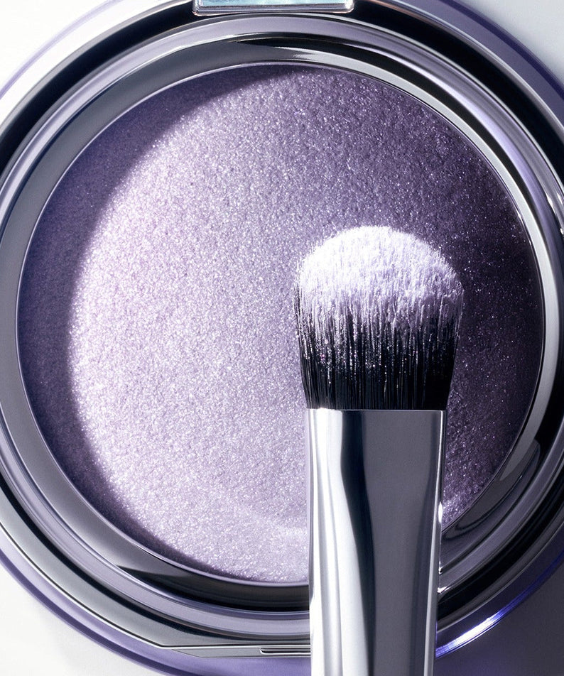 Close-up of ESPOIR Strobing Highlighter [Galaxy Beam Collection] with brush, highlighting its shimmering purple hue.