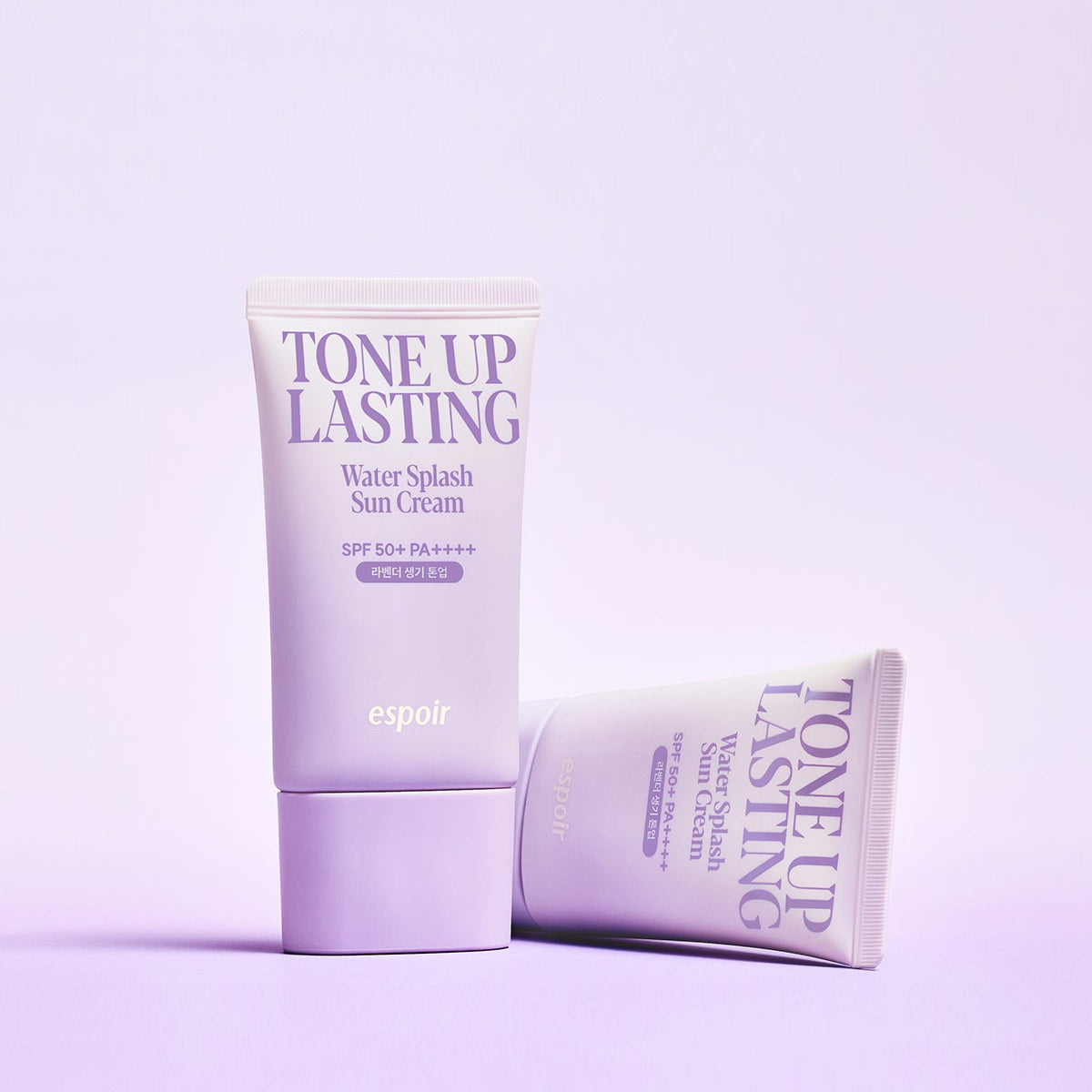 ESPOIR Water Splash Sun Cream Tone Up Lasting SPF 50+ PA++++ in purple packaging on a pastel background.