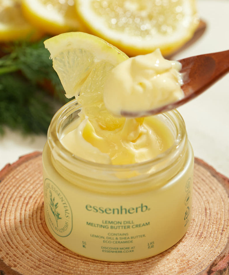 ESSENHERB Lemon Dill Melting Buttercream 55ml in a jar with a spoon and lemon garnish on a wooden slice.