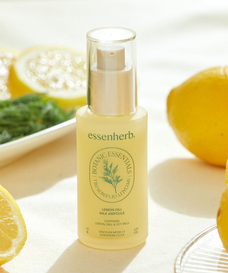 ESSENHERB Lemon Dill Milk Ampoule 50ml surrounded by fresh lemons and dill on a table.