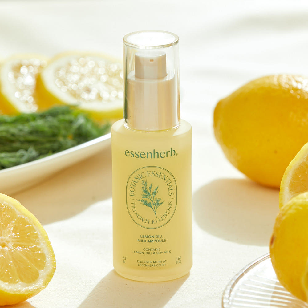 ESSENHERB Lemon Dill Milk Ampoule 50ml surrounded by fresh lemons and dill on a table.