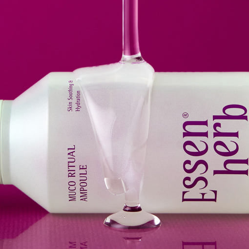 ESSENHERB Mucoritual Ampoule 120ml bottle with pink background showcasing product texture.