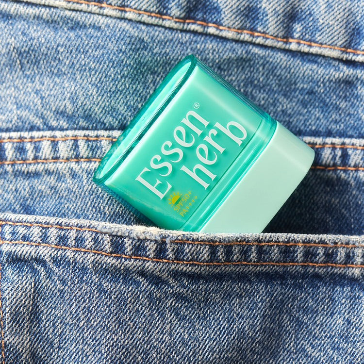 ESSENHERB Multi Defense Cloud Fit Airy Sun Stick 10g in a denim pocket