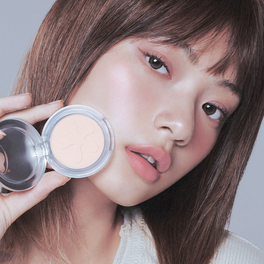 Woman applying ETUDE Face Brightener for glowing skin