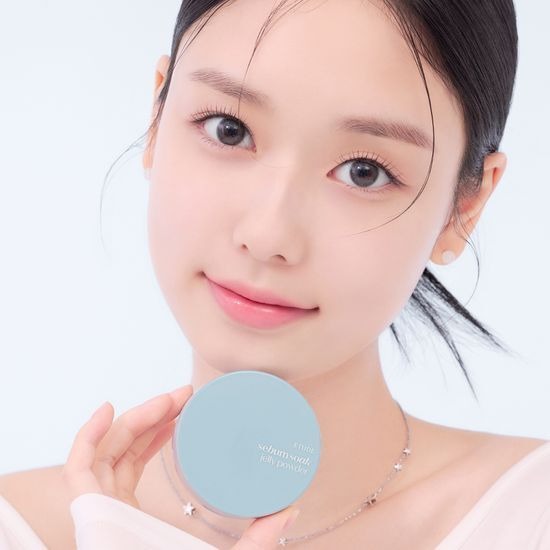 Smiling woman holding ETUDE Fiji-soo Jelly Powder 8g with blue packaging