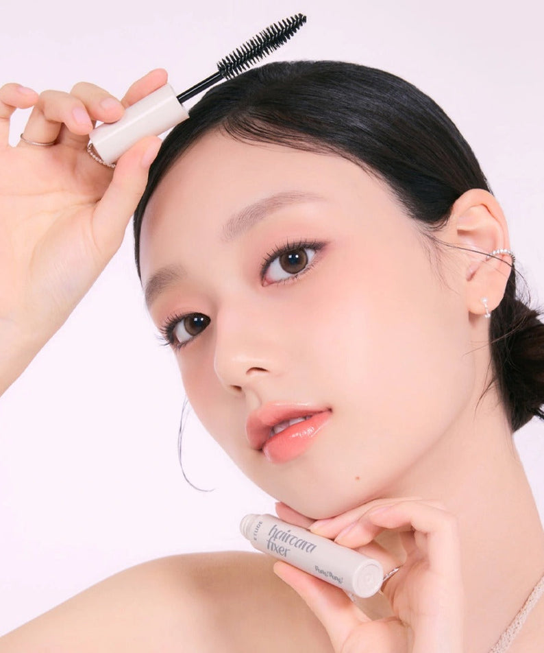 Woman applying ETUDE Pangpang Hair Cara Fixer 10ml with brush applicator for hair styling
