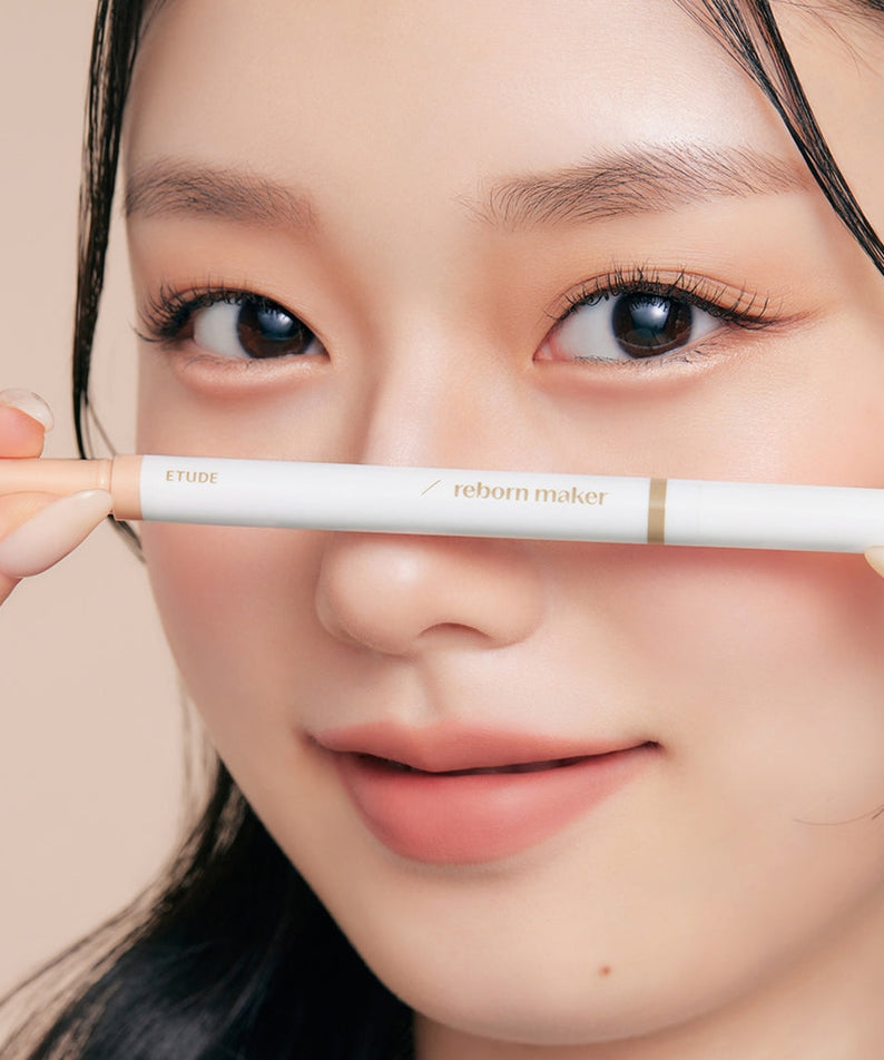 Model holding ETUDE Re-creation Maker Aegyo-sal Liner near eyes showing natural makeup effect.