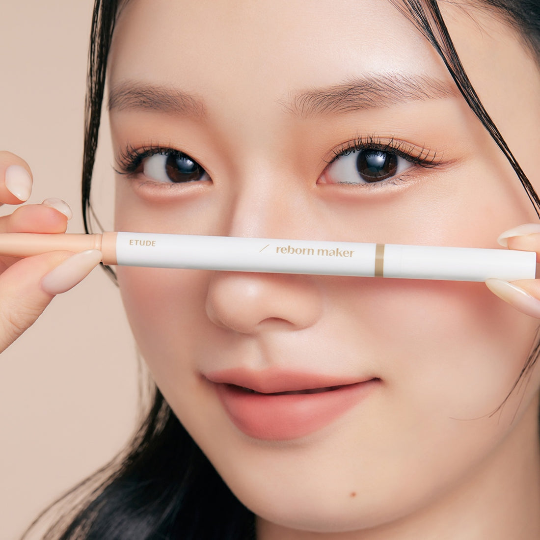 Model holding ETUDE Re-creation Maker Aegyo-sal Liner near eyes showing natural makeup effect.