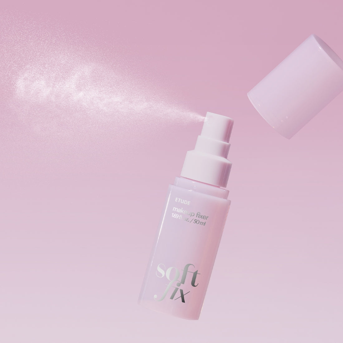 ETUDE Soft Fix Makeup Fixer 50ml spray in action against a soft pink background.