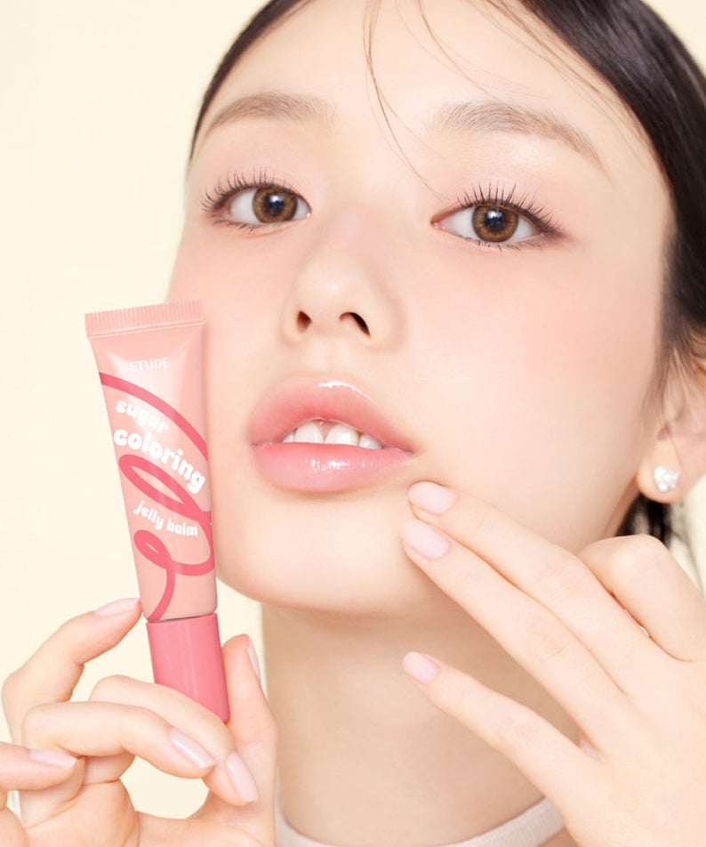 Model holding ETUDE Sugar Coloring Jelly Balm 9g showing moisturizing lip color.