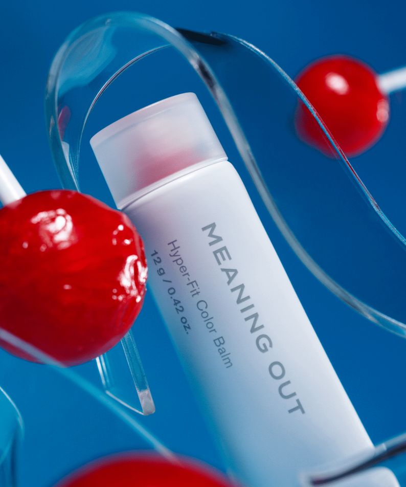 FEEV Hyper-Fit Color Balm with vibrant design, surrounded by red lollipops, offering a smooth and lasting color experience.