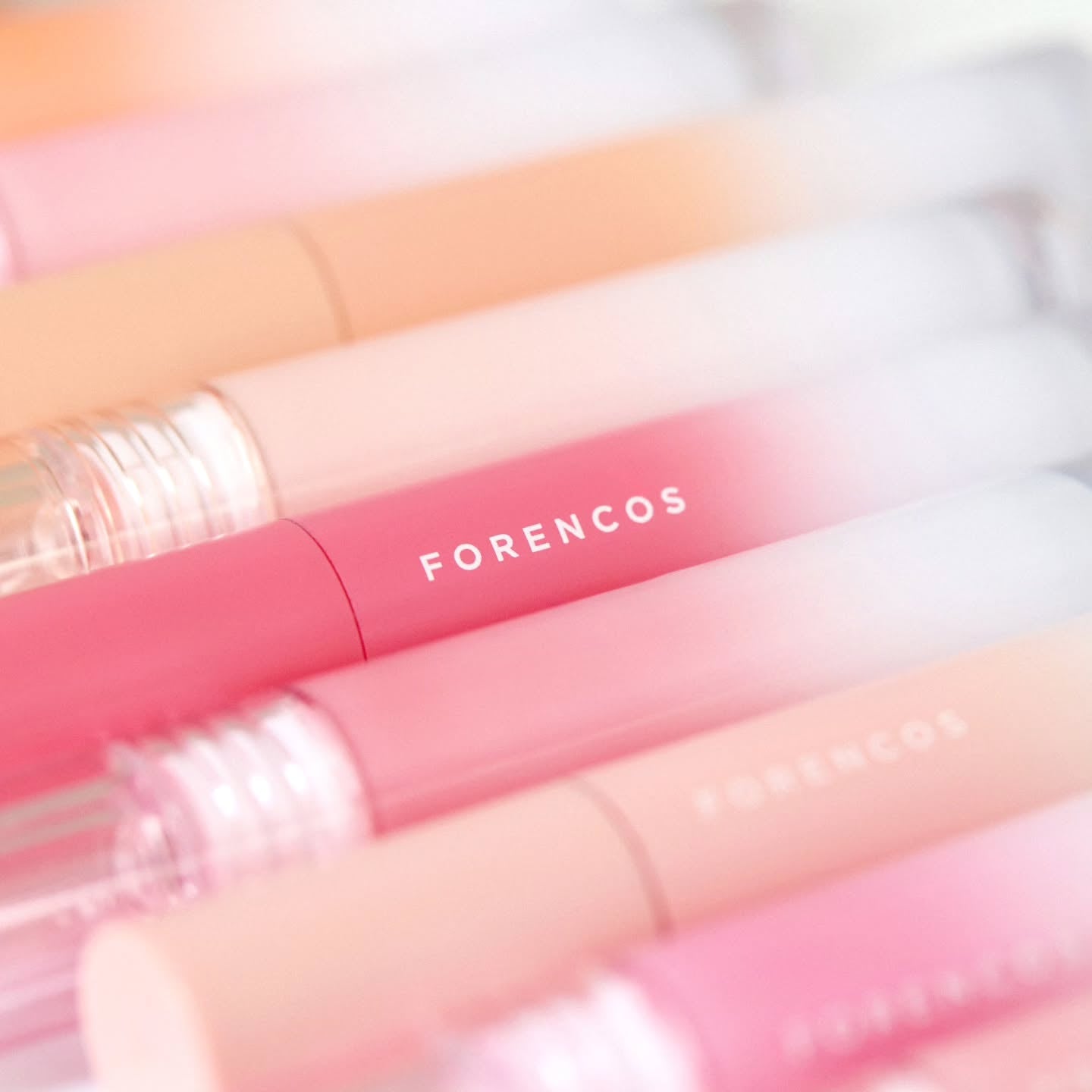 Assorted shades of FORENCOS All Light Mood Glow Tint tubes for vibrant lip color.
