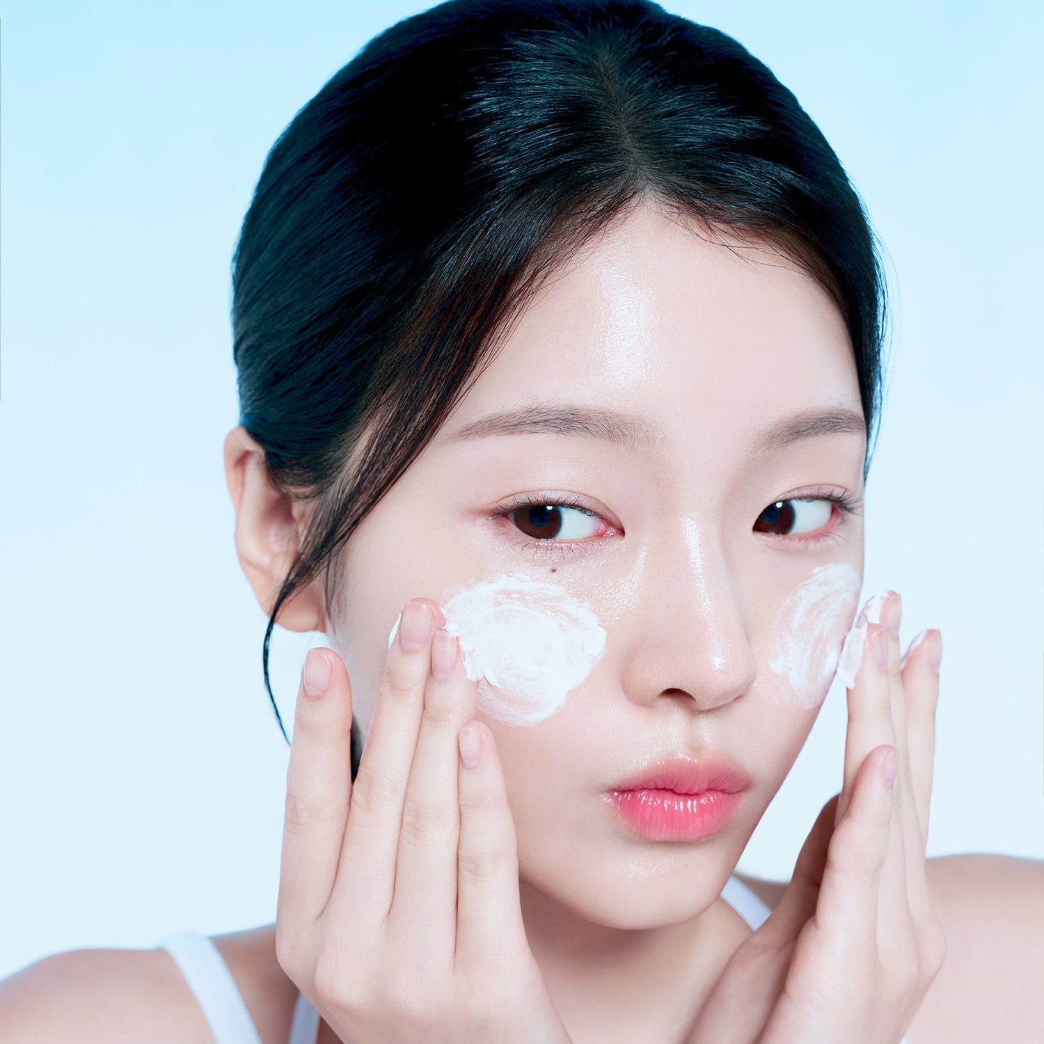 Woman applying FORENCOS Plum C Mild Mild Acidic Cleansing Foam 150g on cheeks