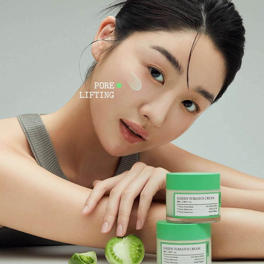Model applying FULLY Green Tomato Cream 90ml with visible green tomato ingredients, promoting skin care benefits like pore lifting.