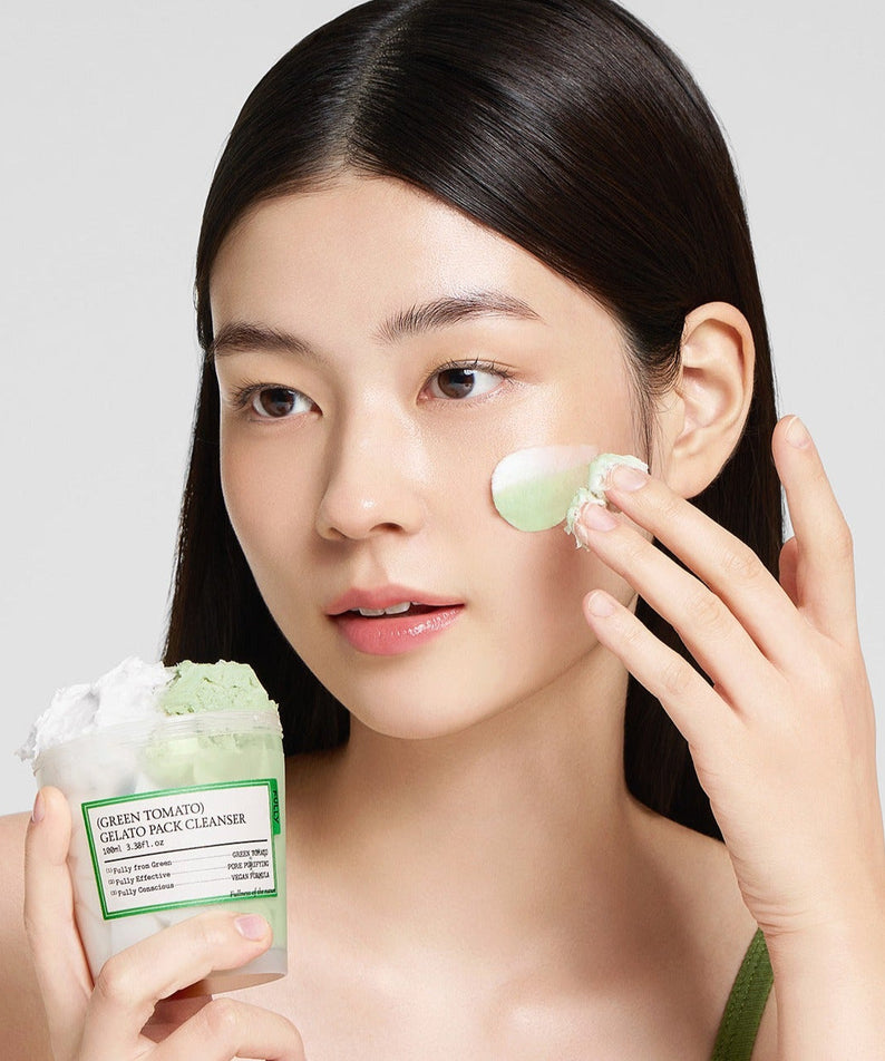 Woman applying FULLY Green Tomato Gelato Pack Cleanser 100ml on her face.
