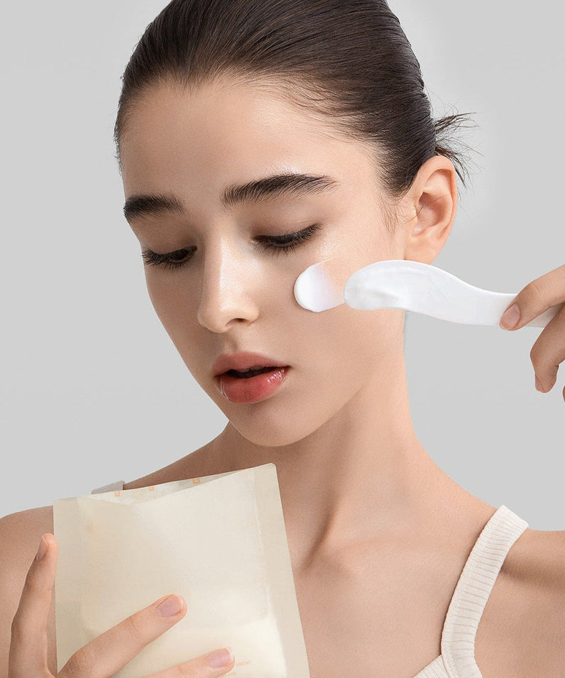 Woman applying FULLY Rice dough modeling mask 4ea with spatula on her face for skincare routine.