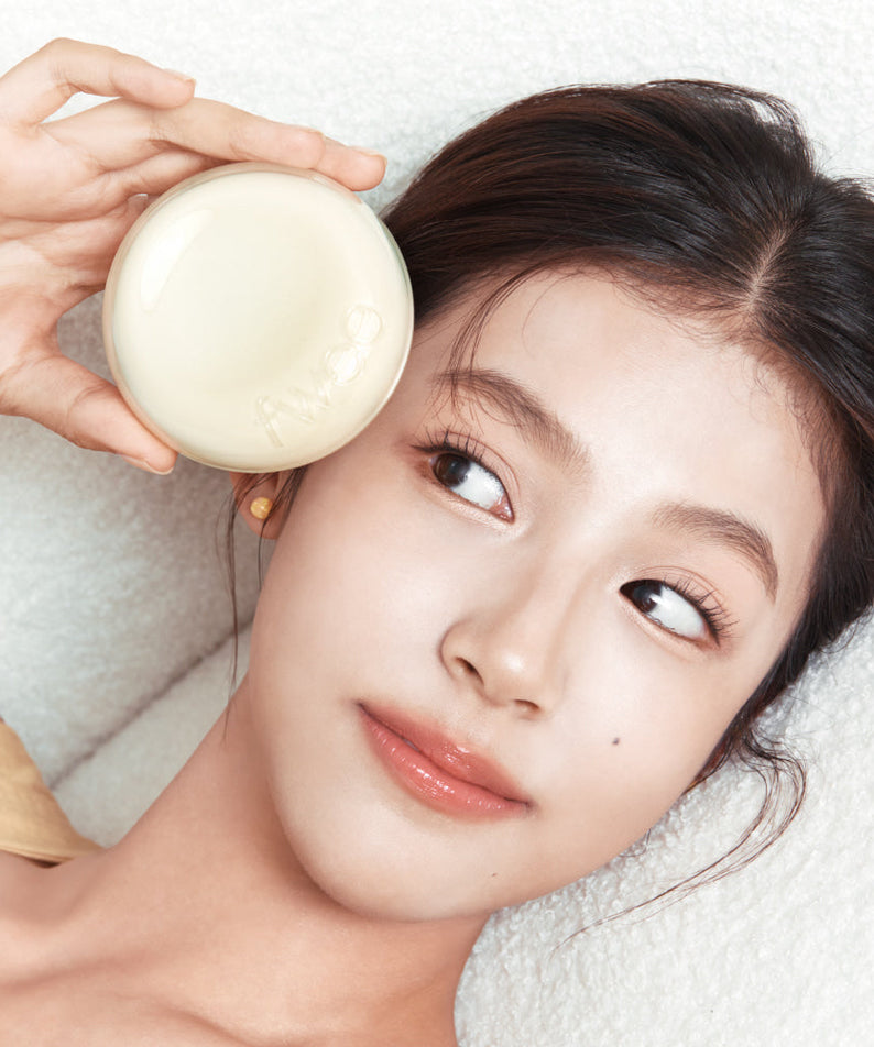 Woman holding FWEE Cover Cushion EGG-FIT with SPF 50+ PA+++ next to her face, showcasing beauty and skincare benefits.