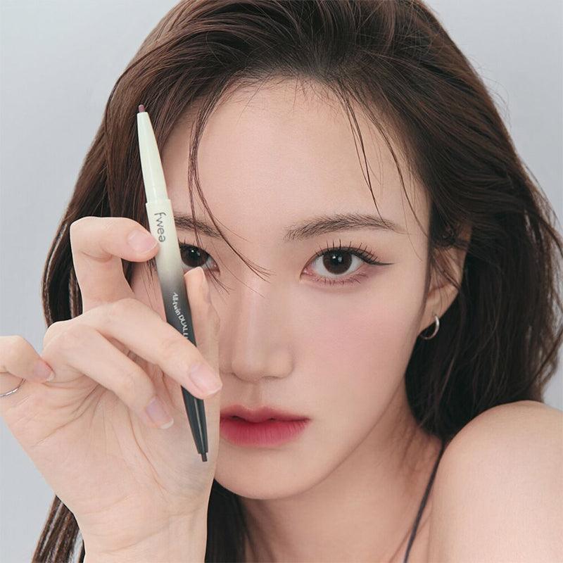 Woman holding FWEE Oltime Dual Liner with a focus on eye makeup application.