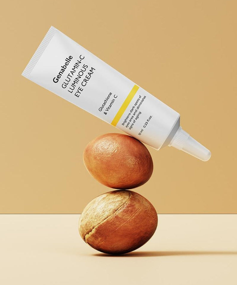 GENABELLE Glutamin-C Luminous Eye Cream 10ml tube balancing on nuts on beige background.