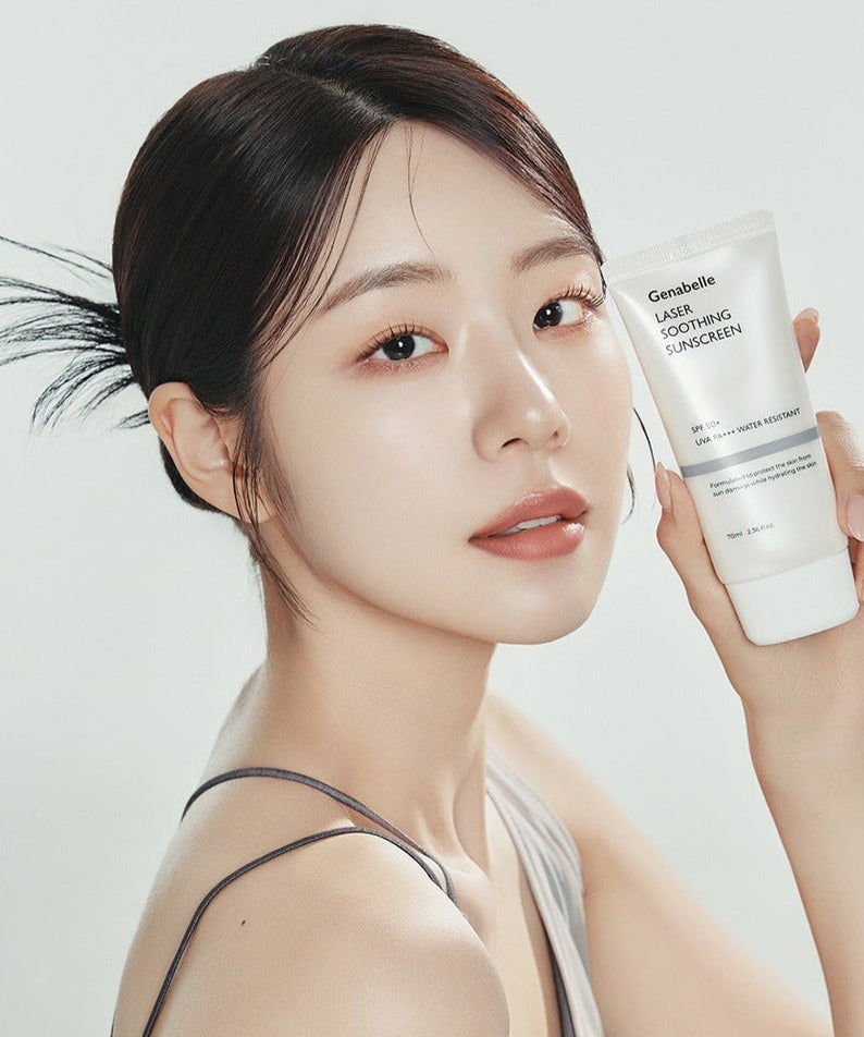 Young woman holding GENABELLE Laser Soothing Sunscreen 70ml, showcasing the product's sleek design and packaging.