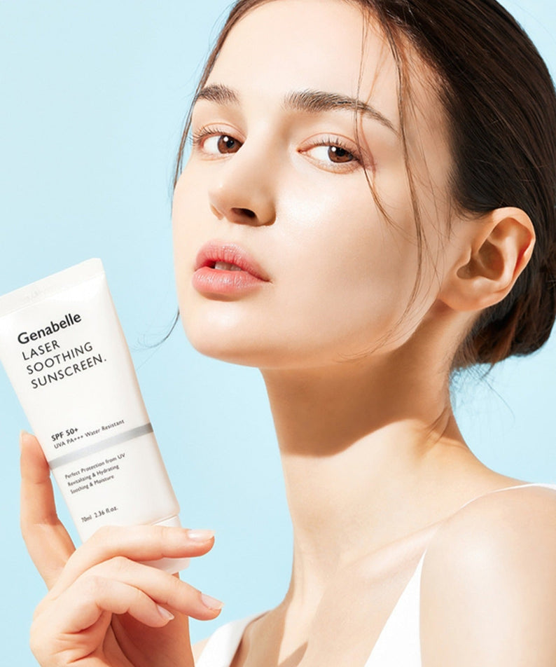 Woman holding GENABELLE Laser Soothing Sunscreen 70ml against a blue background