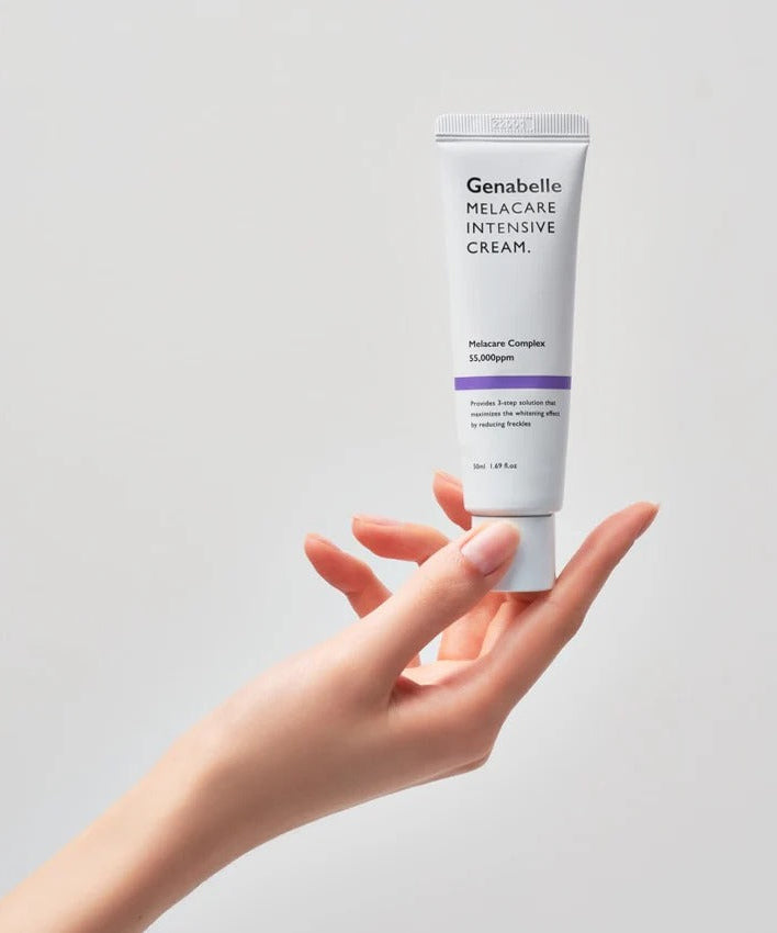 Hand holding GENABELLE Melacare Intensive Cream 50ml product tube against neutral background.