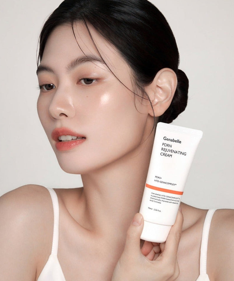 Woman holding GENABELLE PDRN Rejuvenating Cream 70ml, showcasing skincare product.