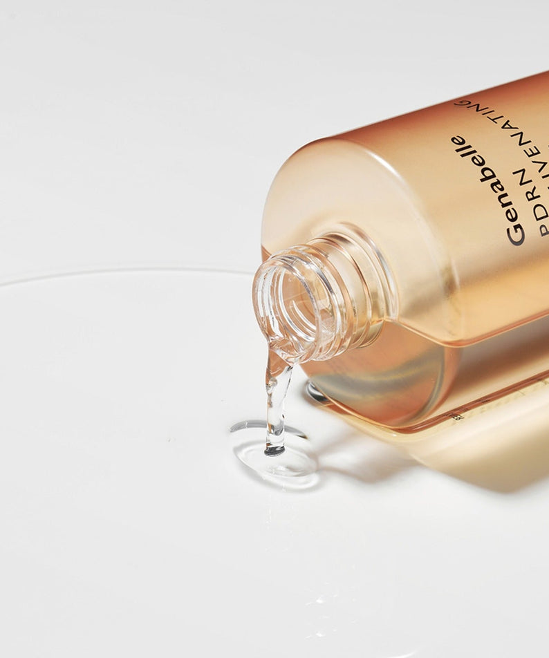 GENABELLE PDRN Rejuvenating Toner 300ml pouring on surface, depicting the product's lightweight texture and skin-refreshing formula.