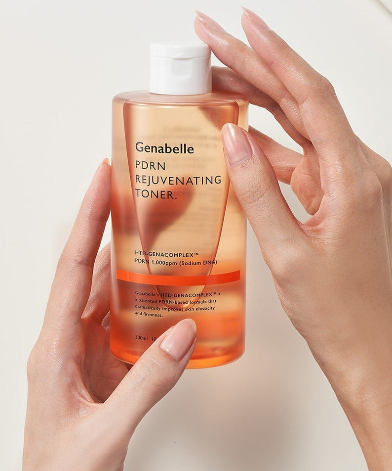Holding a bottle of GENABELLE PDRN Rejuvenating Toner 300ml to showcase its design and features.