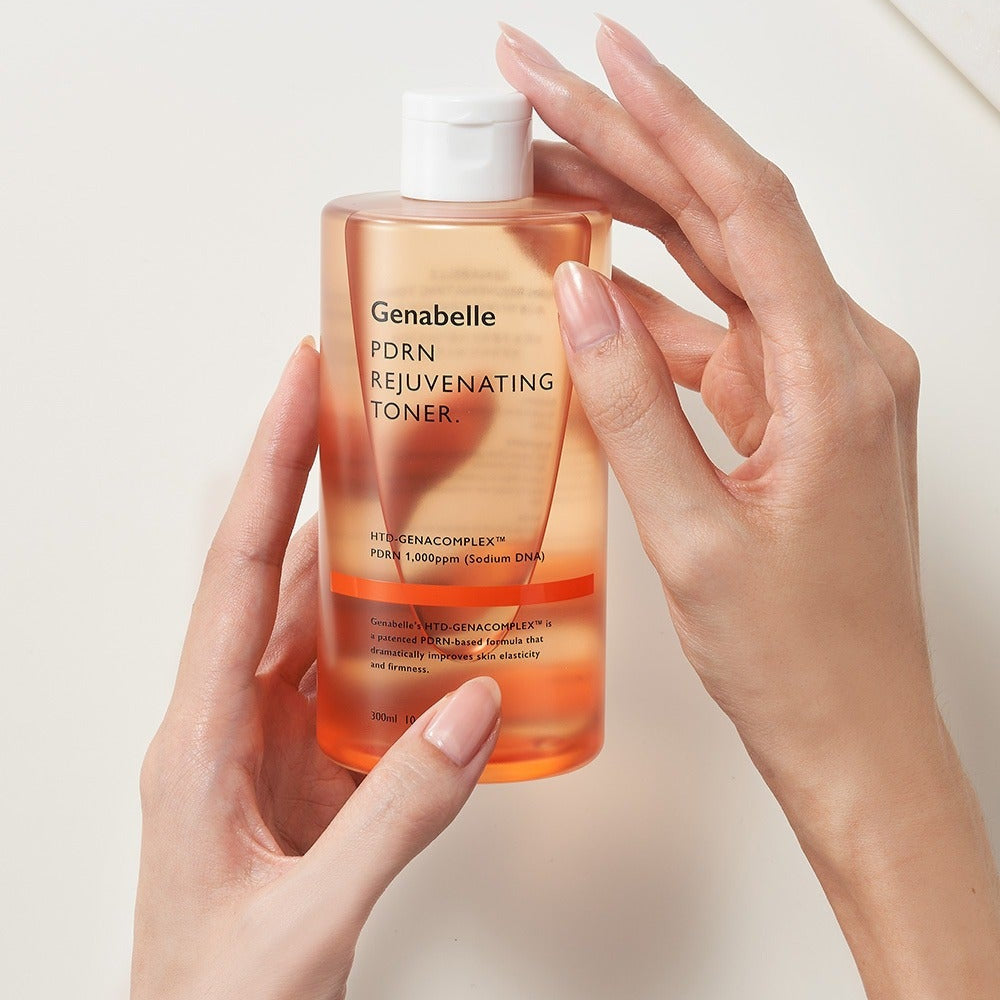 Holding a bottle of GENABELLE PDRN Rejuvenating Toner 300ml to showcase its design and features.