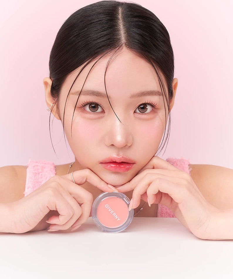 Model holding GIVERNY Dewy Gel Glow Blusher 2.7g with a pink background showcasing the cosmetic product.