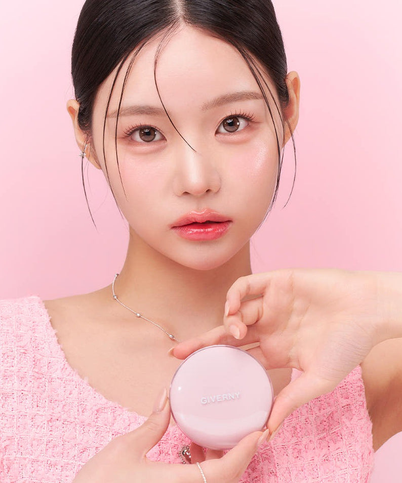 Model holding GIVERNY Dewy Glassy Cushion 13gX2 (Main Product + Refill) (SPF 50+ PA+++) compact against pink background