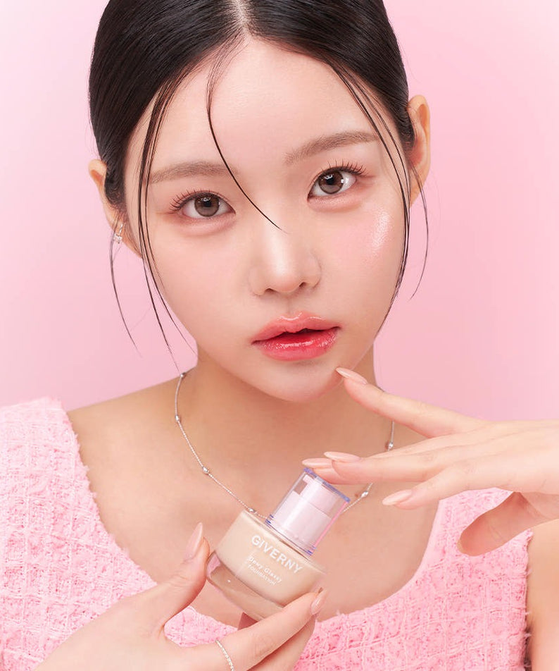 Model holding GIVERNY Dewy Glassy Foundation 30ml (SPF38, PA++), showcasing the product's elegant packaging and dewy finish.