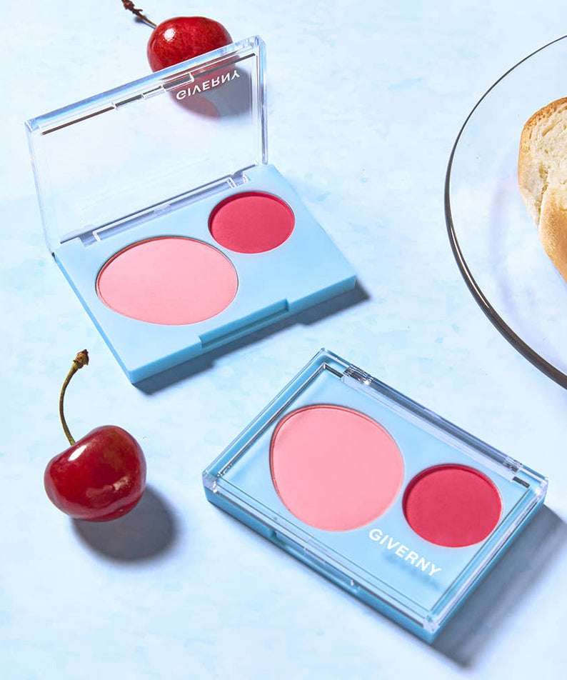 GIVERNY Fluffy Dual Blusher 7.4g with vibrant pink and red tones, open on a light blue background with decorative cherries.