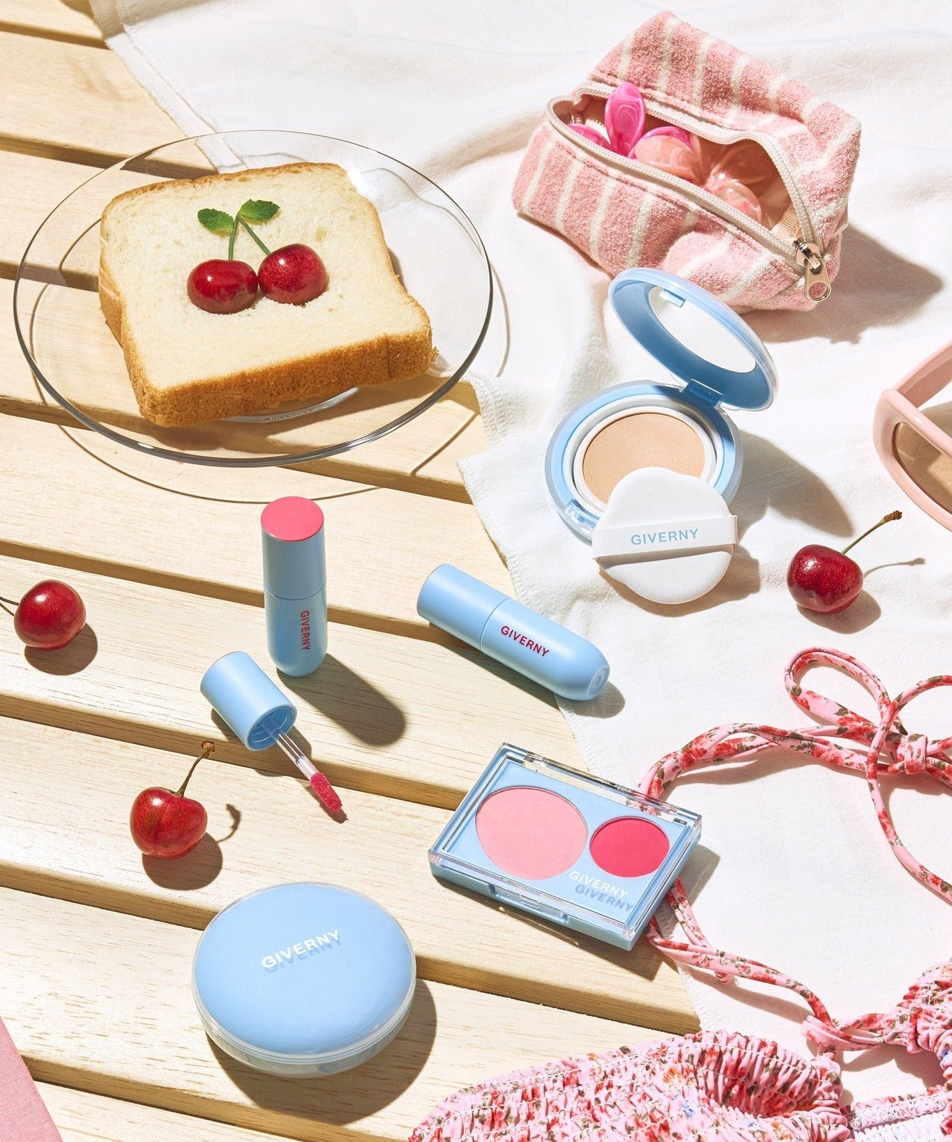 GIVERNY Fluffy Sheer Tint 3.5g displayed on a wooden surface with cherries and makeup items