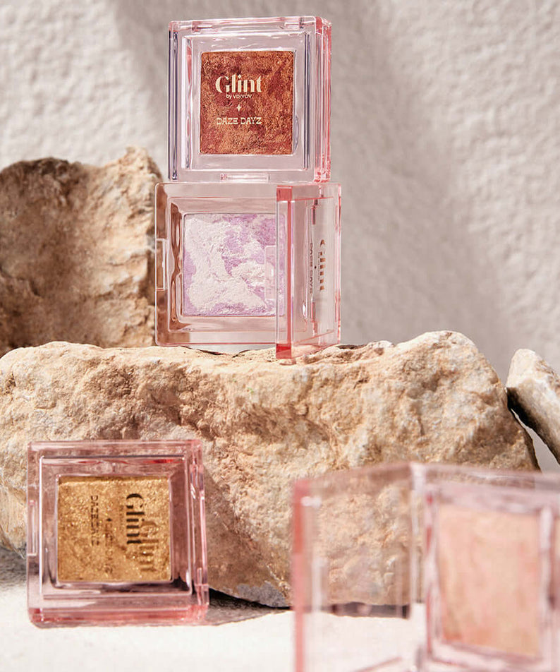 GLINT Glint Highlighter (Marble) makeup displayed on rocks for natural appeal