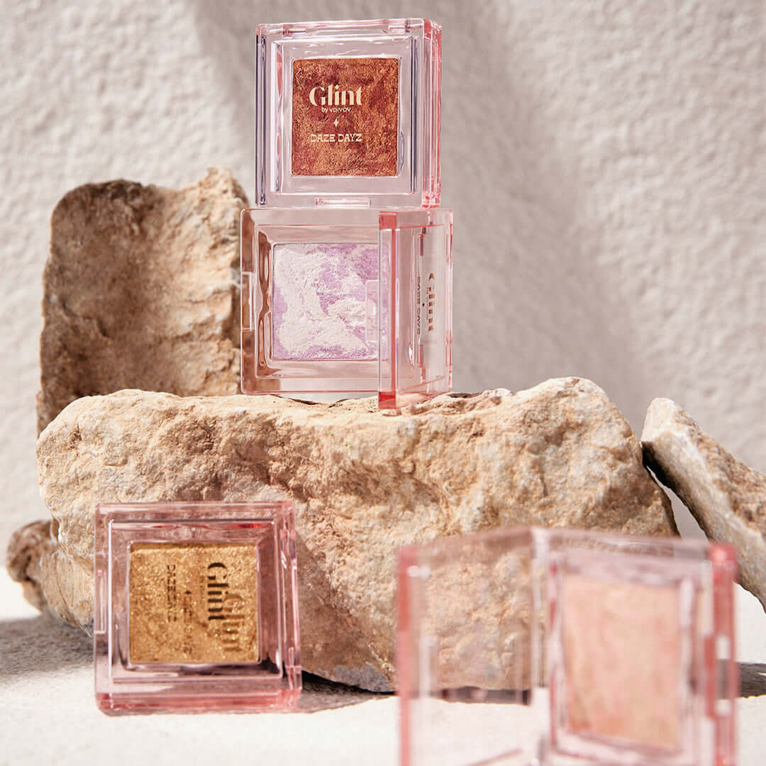 GLINT Glint Highlighter (Marble) makeup displayed on rocks for natural appeal