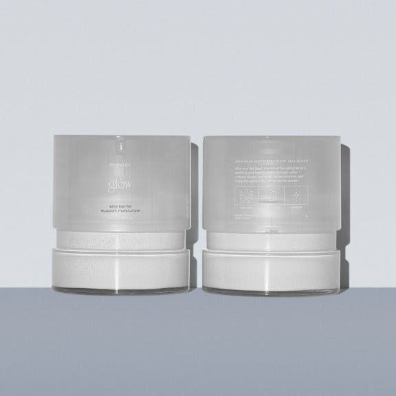 Two containers of GLOW Aloe Barrier Support Cream 50ml on a gray background.