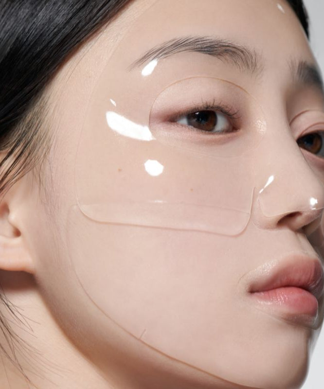 Close-up of a person wearing GLOW Aloe Hydrogel Mask Pack 3ea, highlighting the glossy texture and translucent appearance on skin.