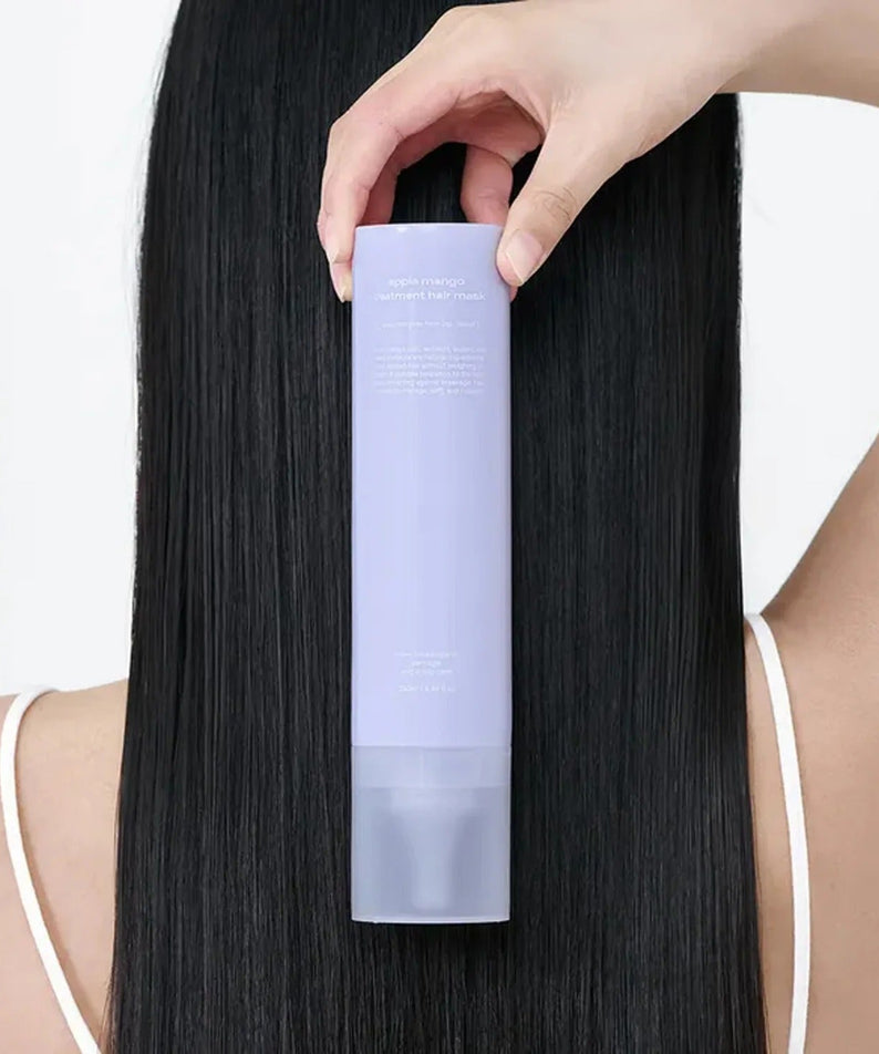 GLOW Apple Mango Hair Treatment 250ml being applied on long black hair