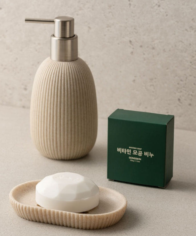 GONGSKIN Aloe Vitamin C Pore Soap 100g on a beige soap dish with dispenser