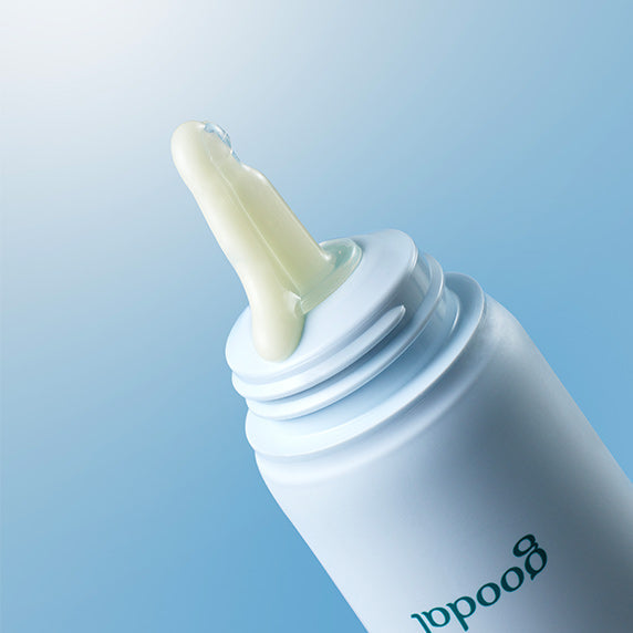 GOODAL Eoseongcho Hyaluronic Acid Sun Serum 50ml in a white bottle with serum texture close-up on a blue background