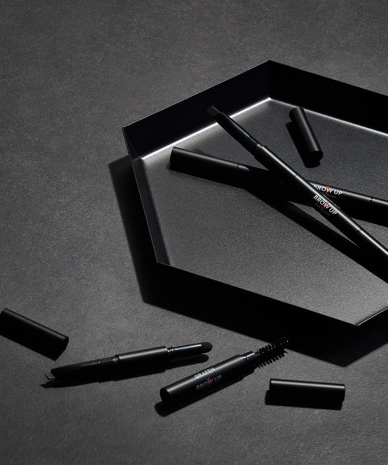 GRAFEN Brow Up Brow Pencil 0.3g displayed on dark tray with caps off, Gentleman Korea men's eyebrow pencil for natural grooming